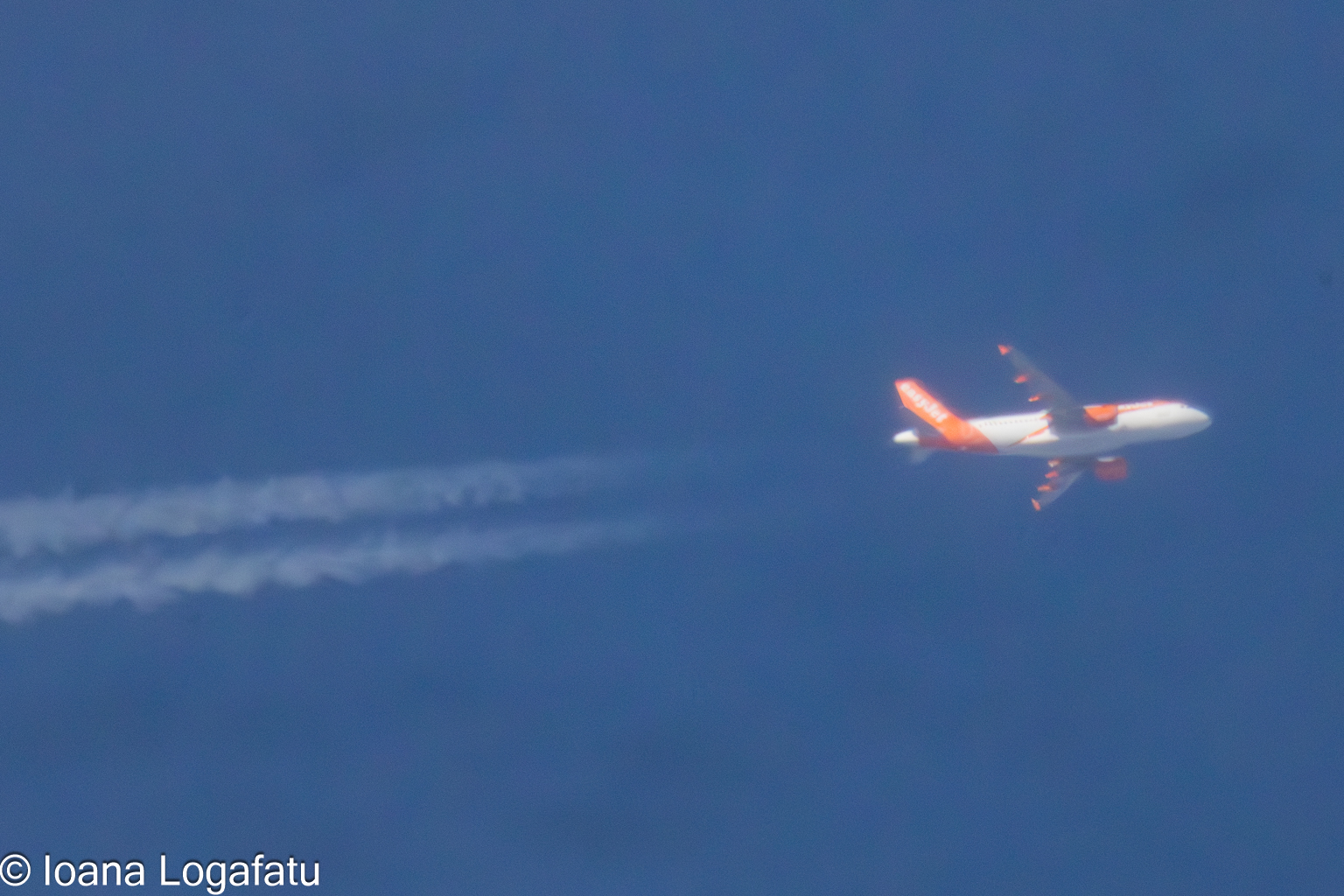 Airplane gliding through a clear blue sky above